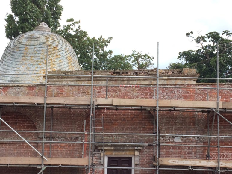 The central stone entablature, shattered by weather and vegetation until all the stonework was fully restored.