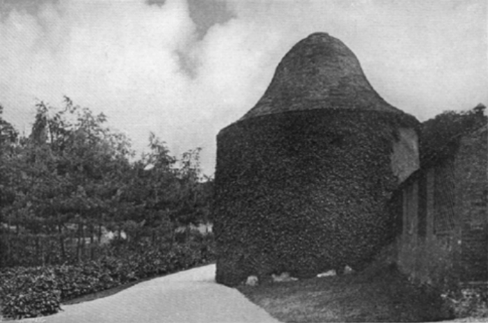 By at least 1908, when this photo was taken, the riding school had ceased to function and had been turned over to become part of the gardens. The C17th dovecote is the gardens most prominent feature with the C18th lean-to stable buildings to the far right. 