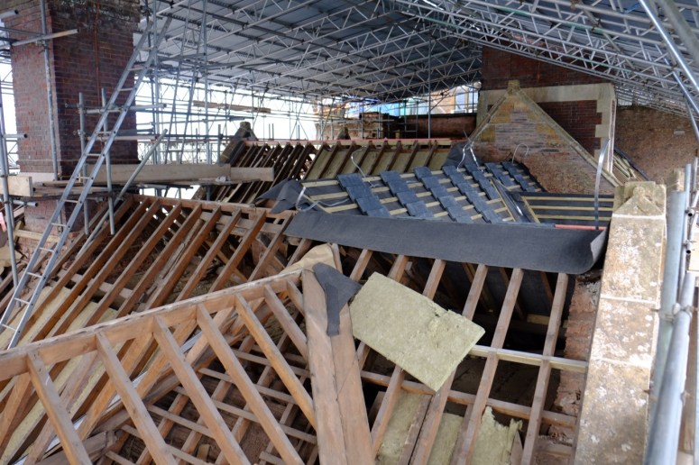 2. Insulation complete, the felt and batons are applied and the slates delivered. (Courtesy of Architectural Thread)