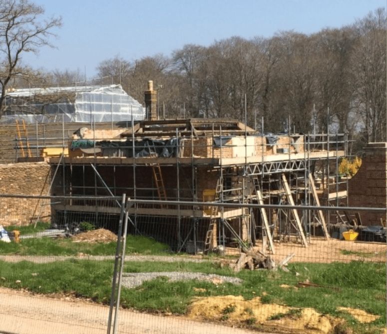 The coach house under scaffolding while undergoing its full restoration. 